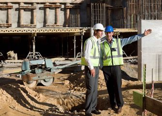 two-construction-workers-discussing-plans-on-site-2024-06-05-18-36-48-utc_11zon.jpg